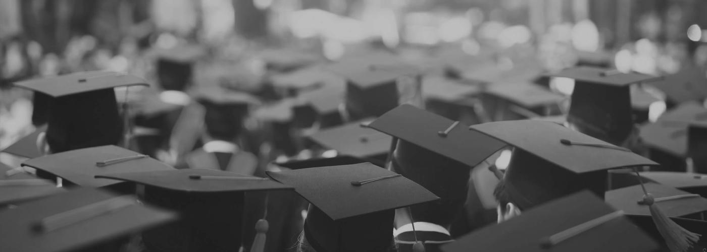 College Students at Graduation with Placards and Tassels